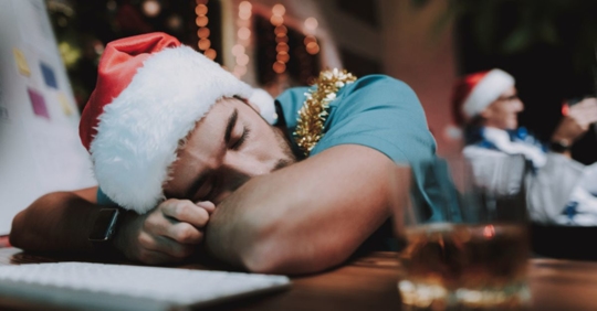 drunk man in Santa hat at bar