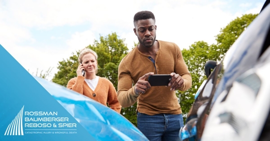Man taking picture of car accident