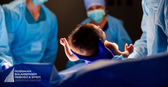 doctors and a newborn