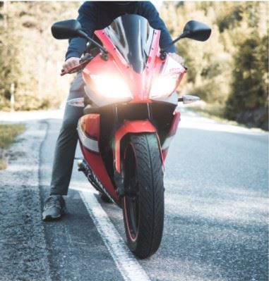 motorcyclist on the side of a highway