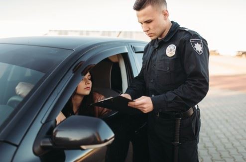 young woman getting pulled over for distracted driving